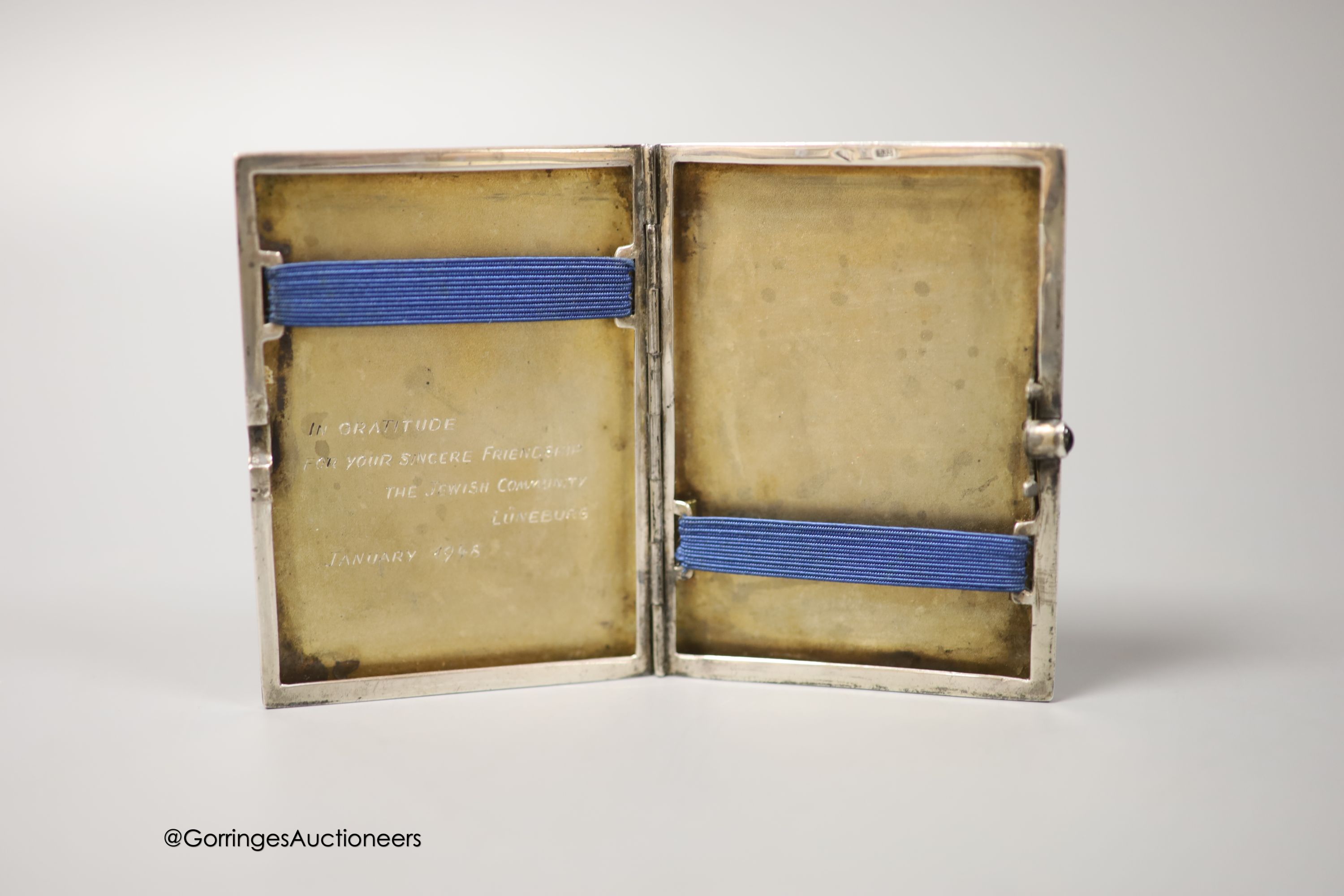 A German 935 white metal and enamel cigarette case, with interior inscription, 'In gratitude For Your Sincere Friendship, The Jewish Community, Luneberg, January, 1948', 87mm, together with a base metal cigar cutter and